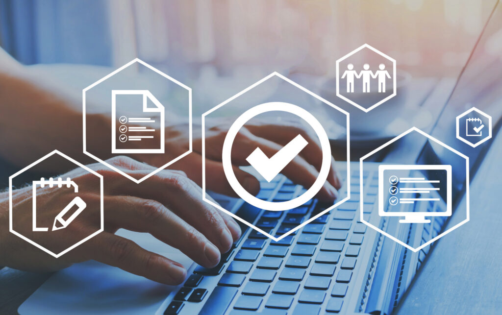 Close up of a man's hands typing on a laptop and white business graphics are overlaying the photo.
