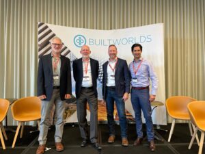 Four business men smiling for photo at the BuiltWorlds 2022 Construction Tech Conference.